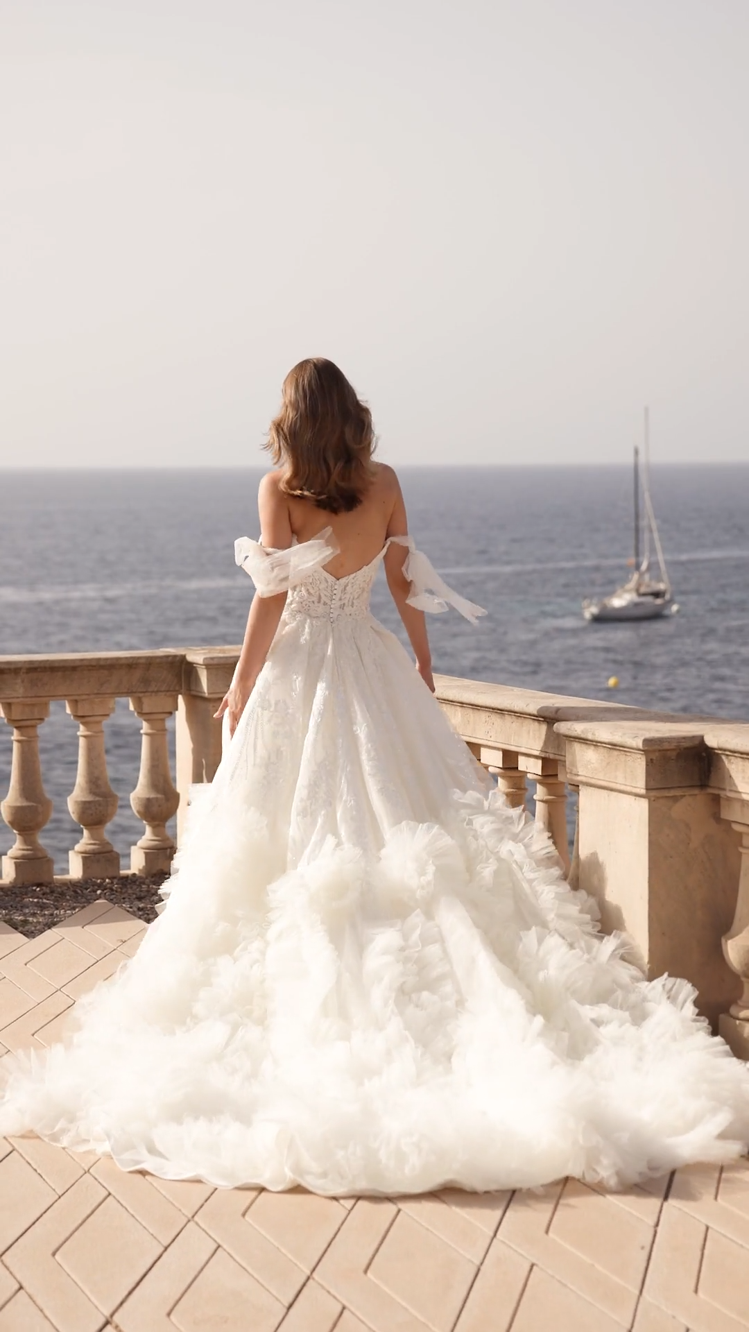 Lavish A-line ruffled hem wedding dress with leg slit and lace scoop bodice and detachable off the shoulder bow sleeves