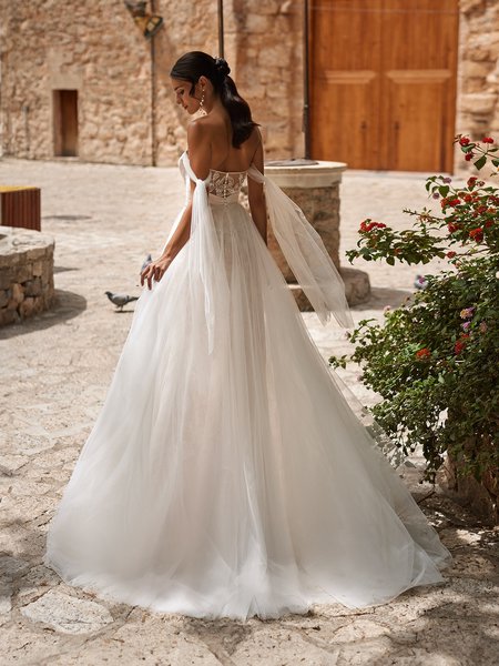 Back view of bride wearing a sweet train wedding dress with illusion scoop back