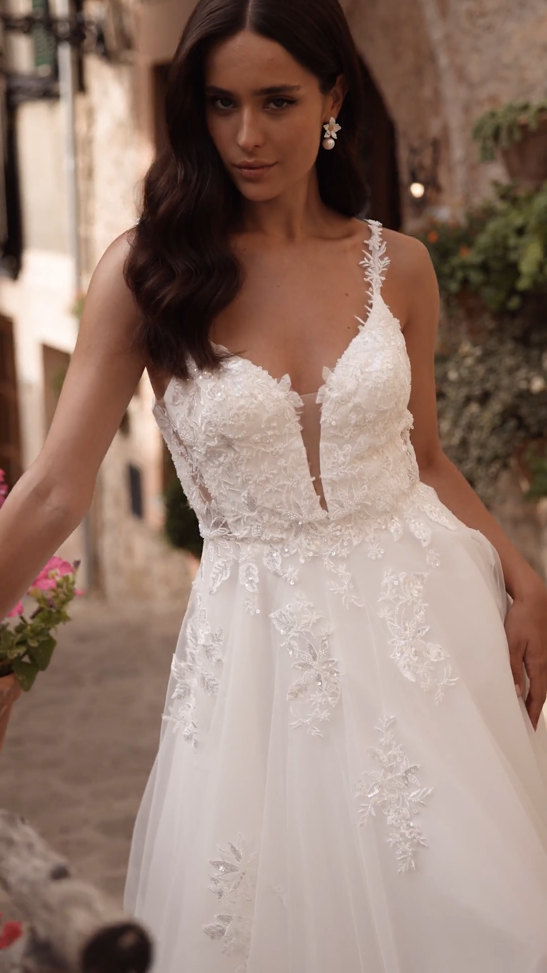 Bride wearing rustic tulle A-line wedding dress with side bodice cutouts and spaghetti straps