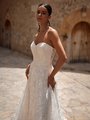 Closeup of bride wearing strapless sweetheart wedding dress with small floral lace