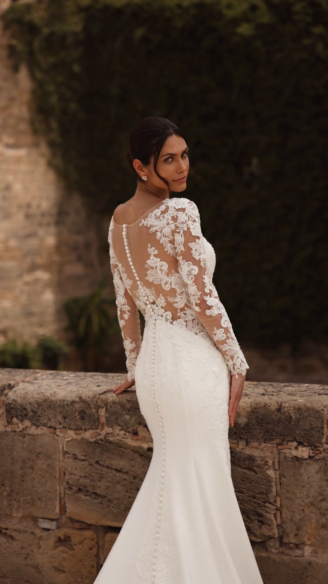 Sexy long sleeve crepe wedding dress with side bodice cutouts and lace scalloped train