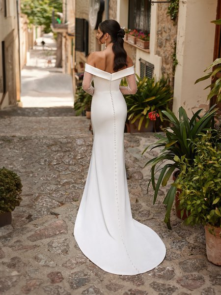 Back view of bride wearing off the shoulder wedding dress with sweep train