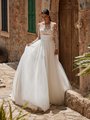 Bride wearing long sleeve illusion bateau wedding dress with full tulle skirt