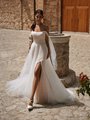 Bride wearing airy tulle and lace wedding dress with leg slit and off the shoulder tulle sleeves