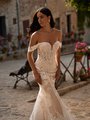 Bride walking in boho southwestern lace wedding dress with sweetheart neckline and off the shoulder sleeves