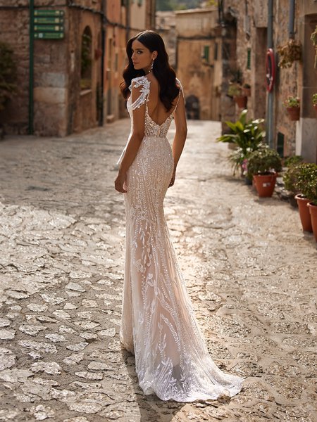 Back view of beaded bohemian wedding dress with deep low back and sweep train